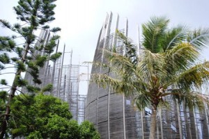 a tall building with palm trees