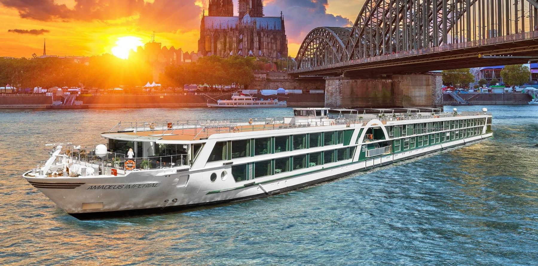 Cruise ship in river below a bridge