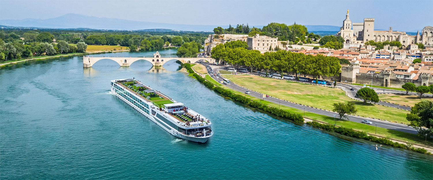 Cruise ship beside a scenic town