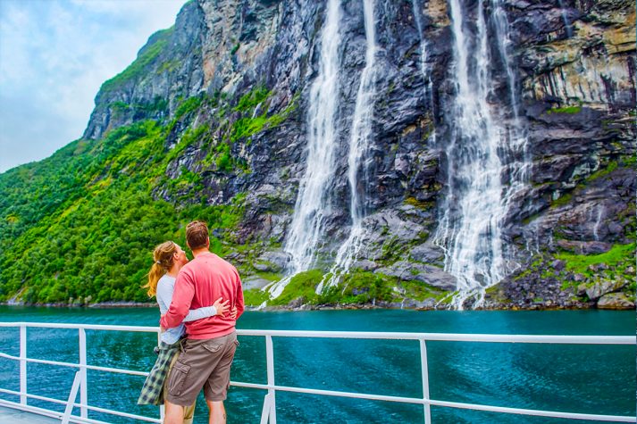 Couple enjoying the Norwegian fjords with Hurtigruten