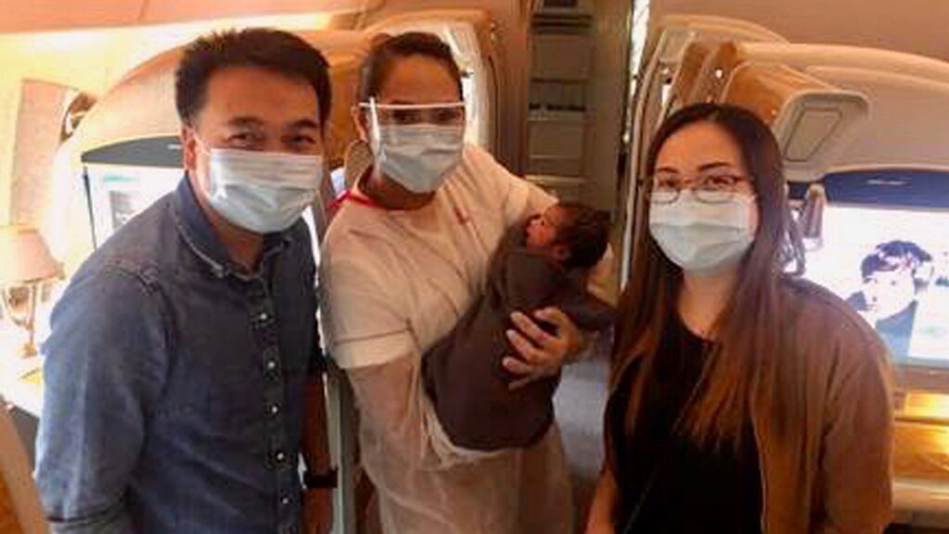 Nurses John and Christine Anne after they delivered a baby girl