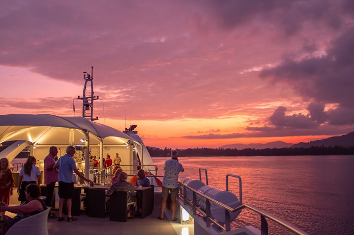 Guests admiring the sunset on the Coral Discoverer