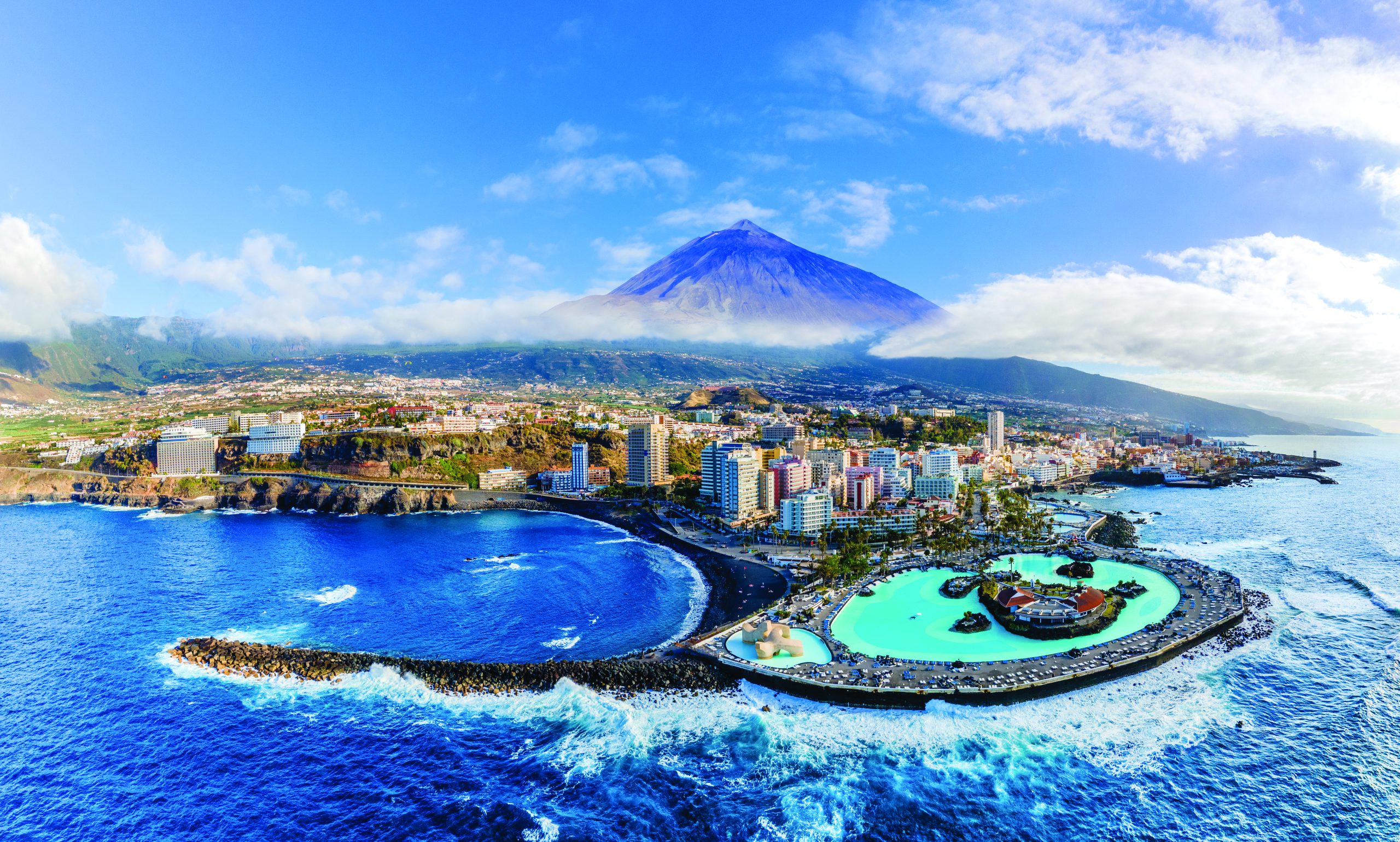 Aerial view with Puerto de la Cruz, in background Teide volcano, Tenerife island, Spain