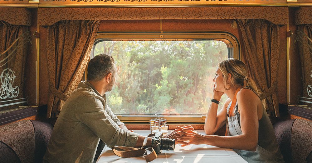 Couple looking out of the window inside the train