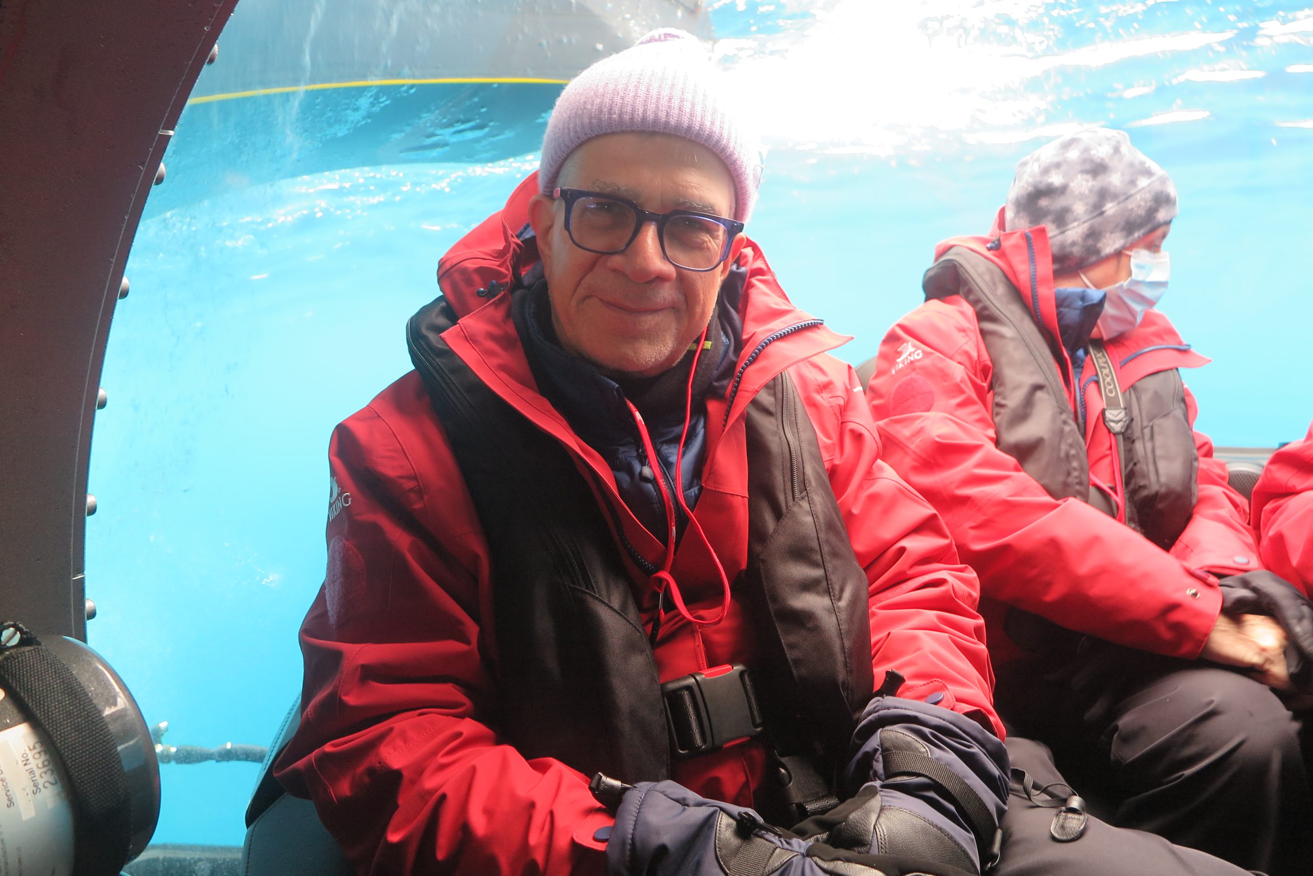 An old man wearing red jacket