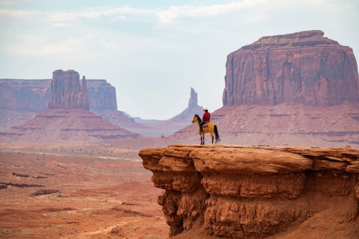 a man on a horse on a cliff