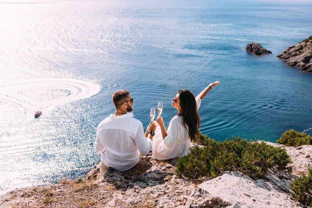 Couple celebrating their holiday overlooking the water