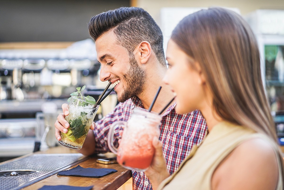 A couple drinking cocktails at a bar on a cruise ship P&O Cruises