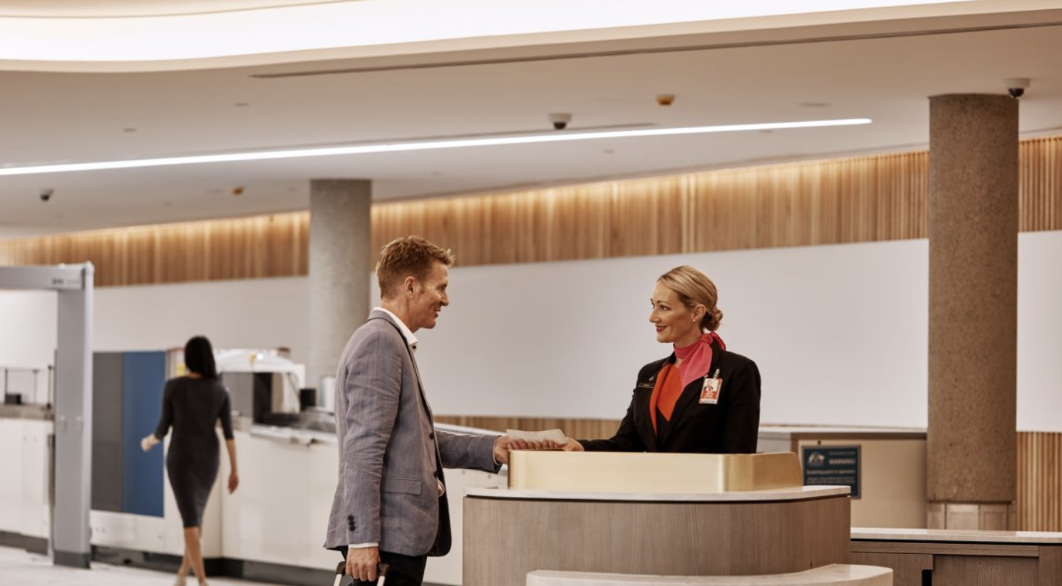 A man ordering flights at the concierge desk.