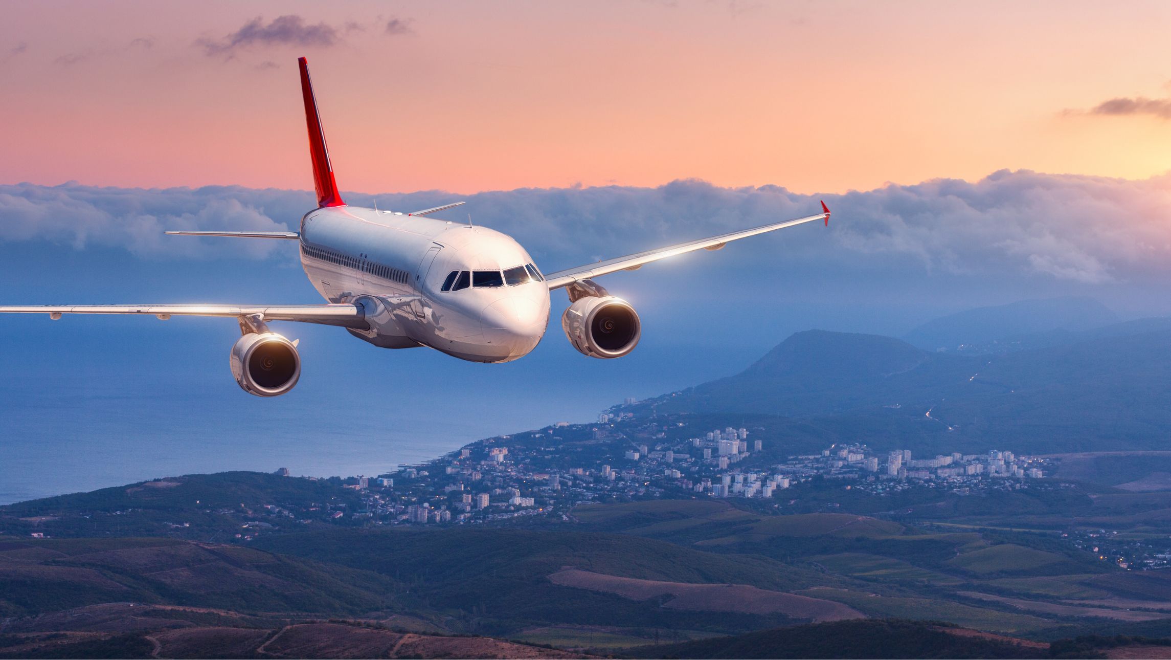 A plane flies in the sky with cruise and fly packages