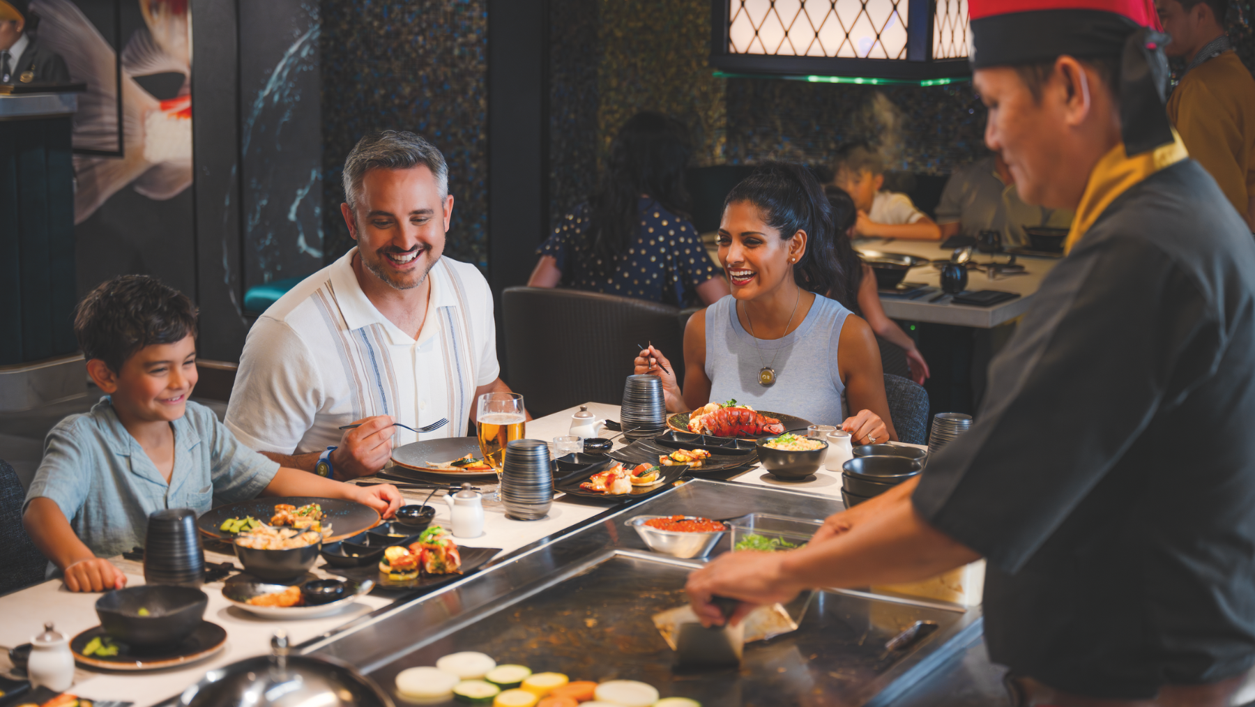a group of people eating at a restaurant