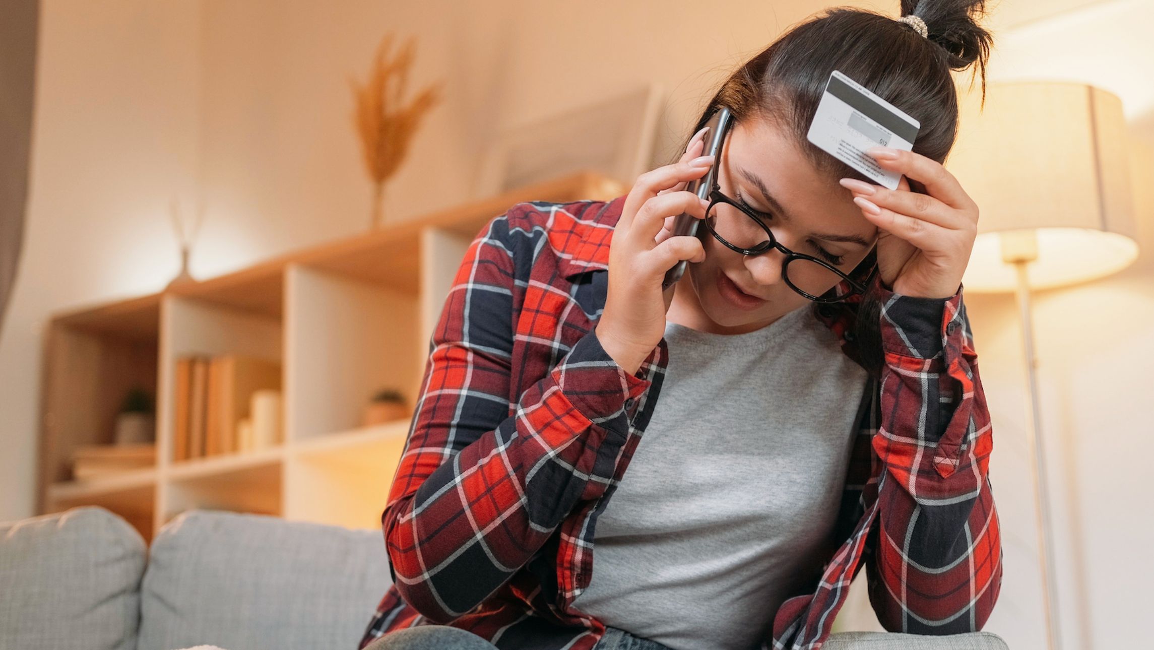 Woman frustrated on the telephone after a scam.