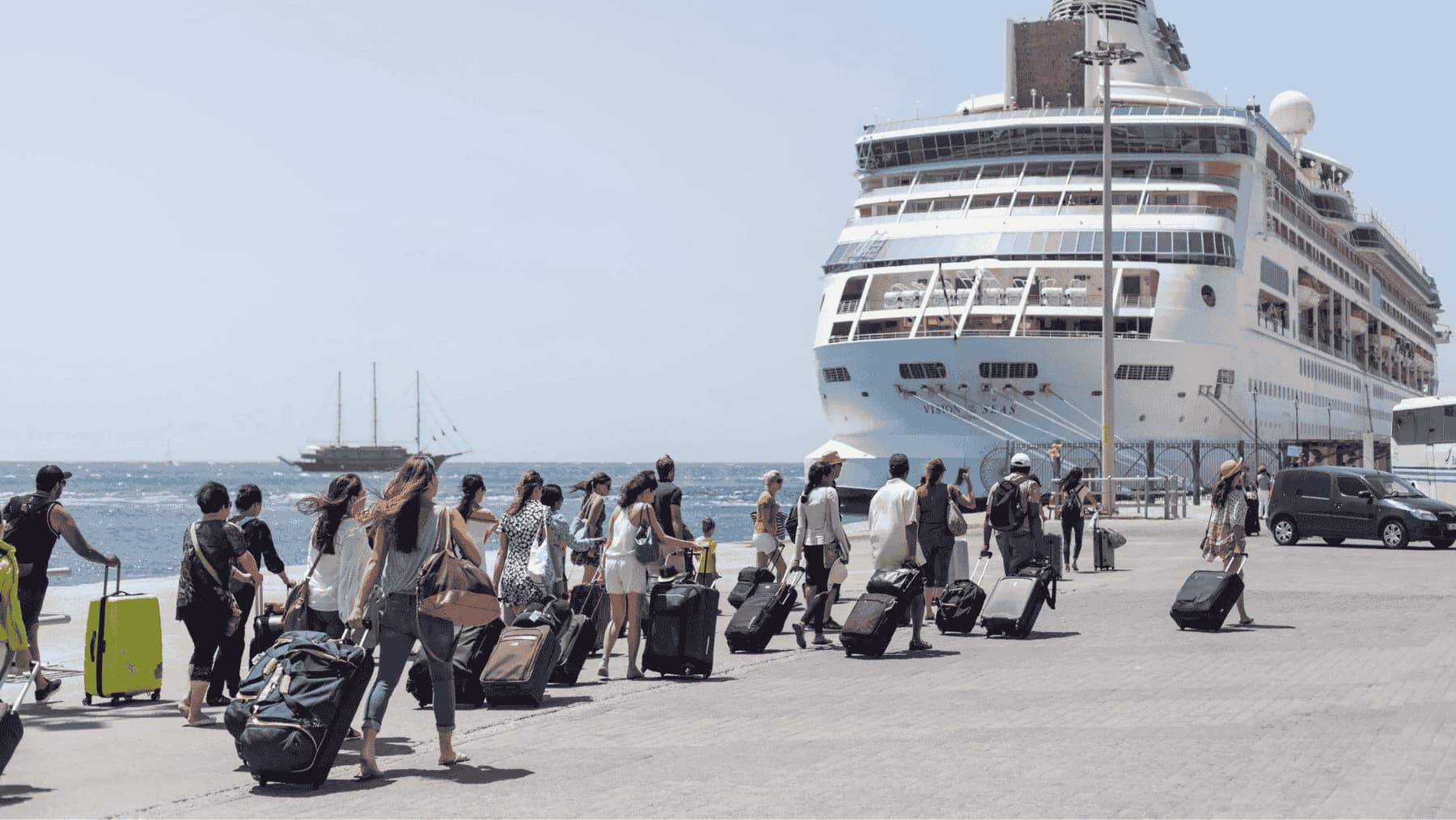 Passengers taking luggage to board Vision of the Seas