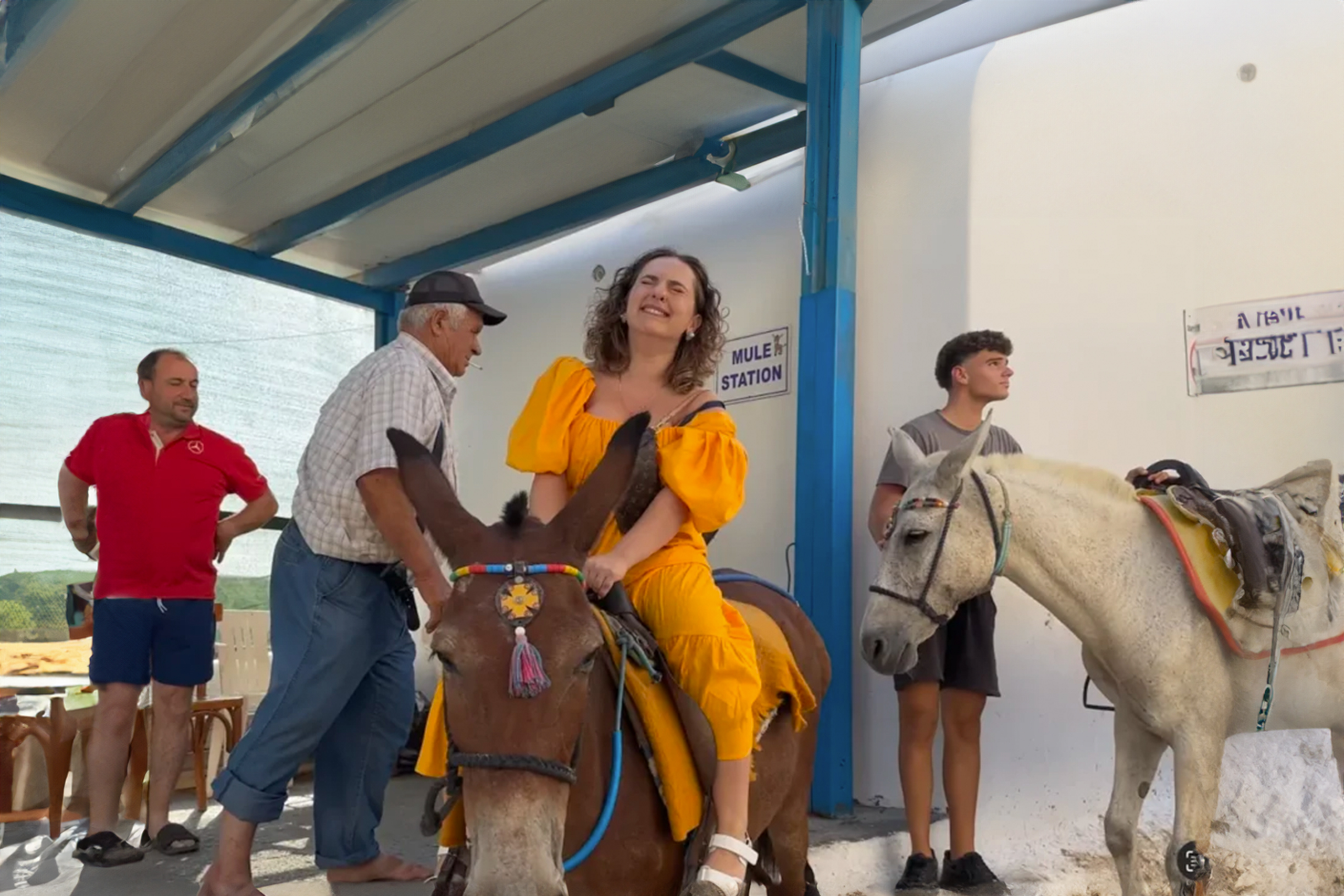 Woman rides Santorini donkeys